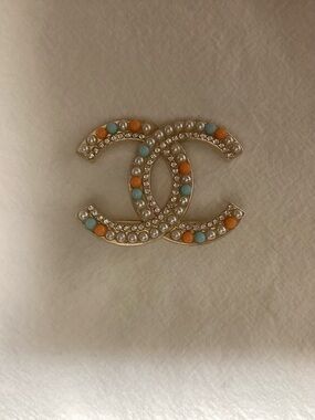 Chanel Interlocking CC Pearl Brooch with Turquoise and Orange Accents.